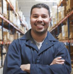 man with arms crossed in a stockroom
